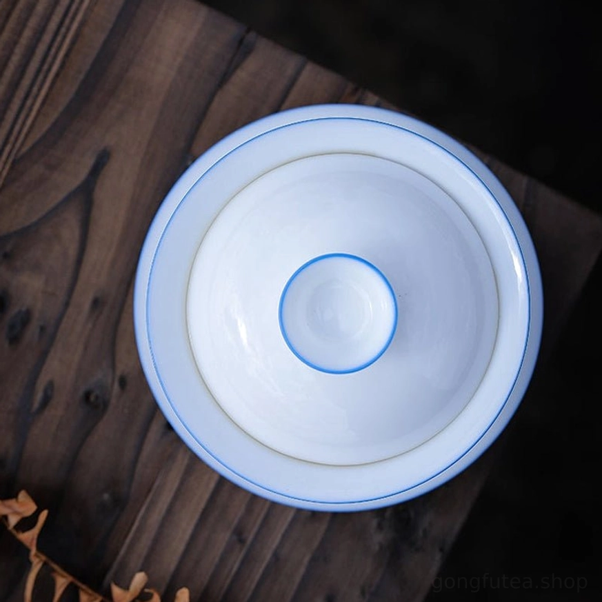 group of multiple size vintage white blue rim gaiwan on wood table