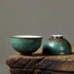 full side view of handcrafted peacock green ceramic chawan kung fu teacup with brown natural texture