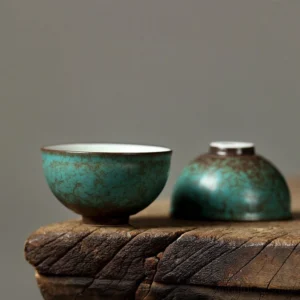 full side view of handcrafted peacock green ceramic chawan kung fu teacup with brown natural texture