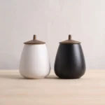 pear shaped ceramic tea canister with bronze metal lid overall view