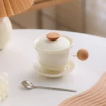 pink glass tea mug with ceramic infuser and wooden handle product view