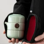 Portable celadon ceramic travel Gong Fu tea set with teapot two cups and black carry case