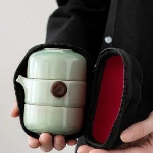 Portable celadon ceramic travel Gong Fu tea set with teapot two cups and black carry case