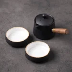 full view of 6.4oz portable ceramic travel tea set with detachable wooden handle and 2 teacups