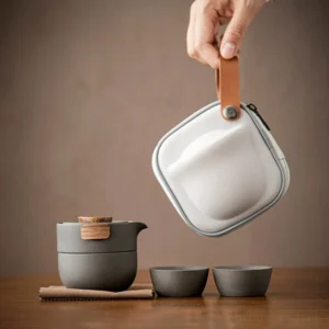 portable ceramic travel tea set with matte dark grey body and wood accents