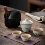 full view of portable ceramic gongfu travel tea set with lotus pattern and black carrying bag