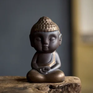 Handcrafted meditating Buddha tea pet main product view on dark background