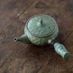 side view of handmade rustic green chinese teapot side handle with built in filter 6.2oz