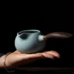 Full product view of sky blue Ru Kiln porcelain Gong Dao Bei with dark wood handle