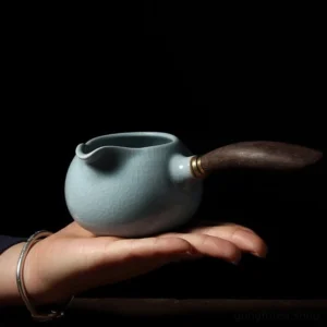 Full product view of sky blue Ru Kiln porcelain Gong Dao Bei with dark wood handle
