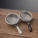 304 stainless steel fine mesh tea strainer with ceramic handle on wood background