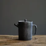 vintage black chinese teapot full view handcrafted ceramic with built-in infuser