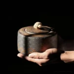 vintage bronze ceramic tea canister with wave relief full product view