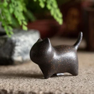 handcrafted ceramic cat tea pet displayed on tea tray
