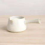 Full side view of vintage cream white ceramic Gong Dao Bei tea pitcher