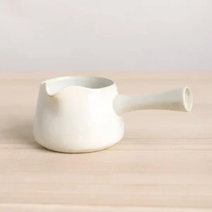 Full side view of vintage cream white ceramic Gong Dao Bei tea pitcher