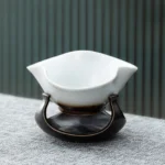 vintage handcrafted ceramic tea strainer with gradient brown glaze on stand