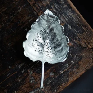 vintage leaf shaped tin tea strainer silver tone side view