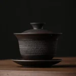 full view of handcrafted textured vintage dark ceramic chinese gaiwan