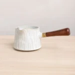 white ceramic gong dao bei with detachable wooden handle bark texture side view