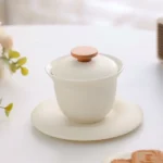 white porcelain gaiwan with wooden knob full product view on wooden table